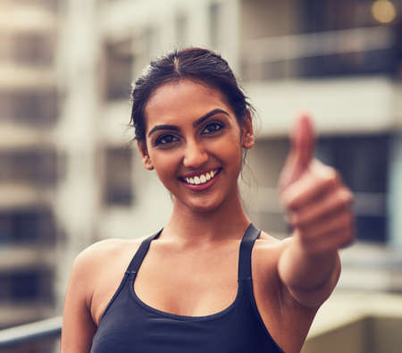 Make the right choices in life. Shot of a beautiful young woman exercising outdoors.の写真素材