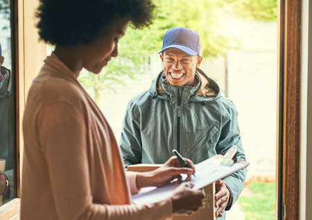 All I require is a signature please. Shot of a woman signing for her delivery from the courier.