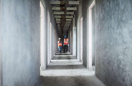 Building assessment by the best in the business. Shot of a young man and woman using a digital...