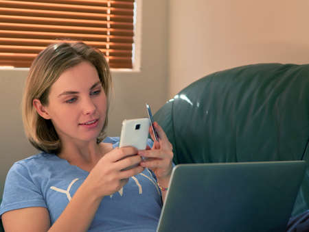 Beating the queues by shopping online. Shot of a relaxed young woman making an online payment with...