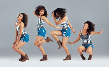 Expressions through dance. Composite image of a carefree young woman posing in studio.の写真素材