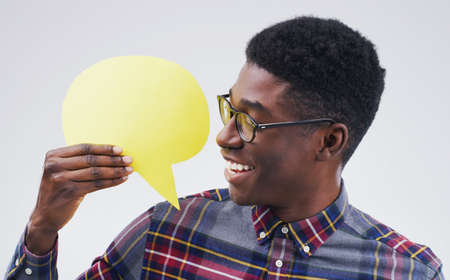 So this is what everyone is busy talking about. Shot of a handsome young man holding a speech bubble...