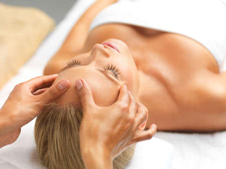 Feeling soothed and super relaxed. A beautiful young woman relaxing in a spa.の写真素材