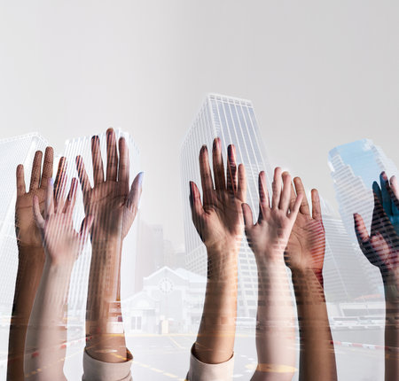 The city is in our hands. Shot of a city superimposed over an unidentifiable business team putting their hands up together.の写真素材