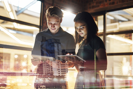 We make connecting with the business world easier for you. Shot of two young businesspeople using...
