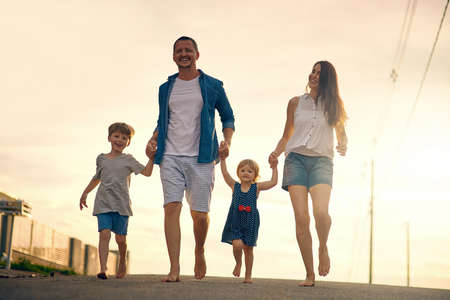 After supper we love taking a walk together. Shot of a young family taking a walk down the road...