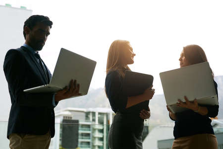 Theyve each come with their own ideas. Cropped shot of three coworkers meeting with their laptops in...
