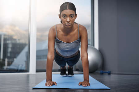 Always be ready to cross that line. Shot of an attractive young woman busy doing stretching...