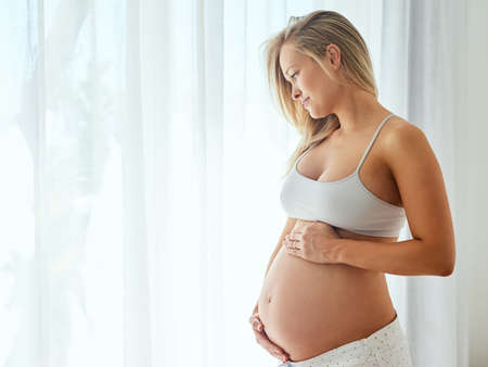Whats more beautiful than a baby bump. Shot of a beautiful woman touching her pregnant belly.