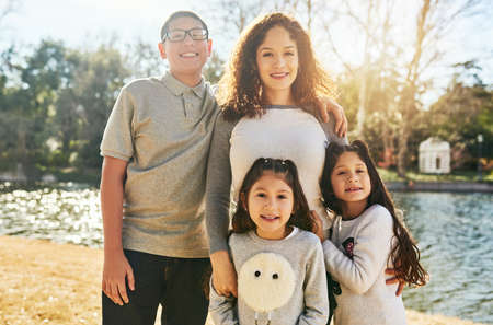 Nature is all around and here to enjoy. Portrait of a happy family spending time together outdoors.