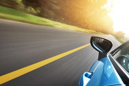 Cruising the open road. Shot of a car driving on a road.