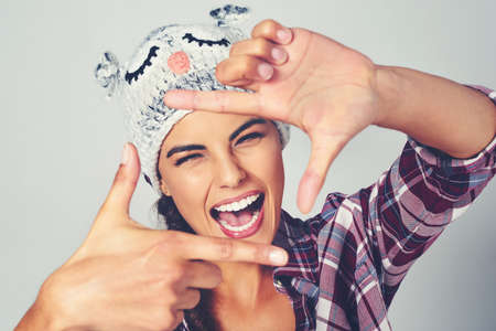 I just cant help but to be me. Cropped shot of a young woman posing with a character beanie.