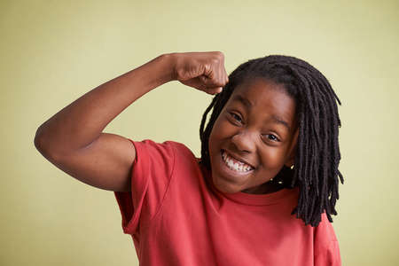 Check these muscles out. Studio portrait of a young boy showing off his muscles.の写真素材