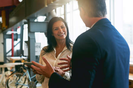 Theyre not afraid to go big with their ideas. Shot of two businesspeople having a discussion in an office.の写真素材