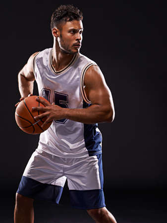 Got game. Studio shot of a basketball player against a black background.の写真素材