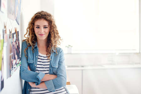 Shes a creative professional. Portrait of a young graphic designer standing in her office.