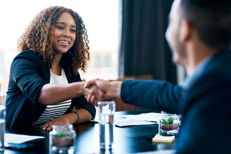 Welcome to the company. Cropped shot of two business colleagues shaking hands during a meeting in...
