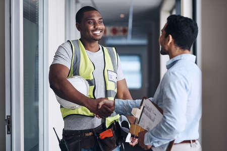 Well see you on Monday. Shot of two young architects standing together and shaking hands after a...