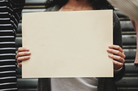 Its a cause worth fighting for. Cropped shot of an unrecognizable woman holding a sign while taking part in a political rally.の写真素材