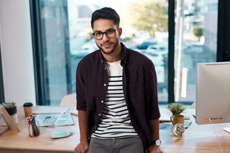 I am proud of what I do. Cropped portrait of a handsome young businessman wearing spectacles and...