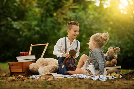 And what did the monkey say. Shot of a little boy and his sister out reading in the woods.の写真素材