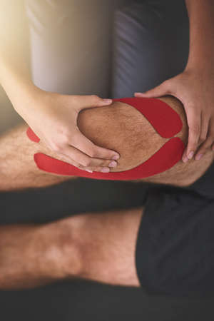 Lets see how this knee is doing. High angle shot of an unrecognizable female physician working with...