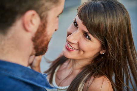 Theres love in her eyes. High angle shot of an affectionate young couple looking lovingly into one...