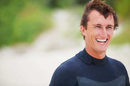 Surfing is my happy space. Shot of a handsome young surfer.