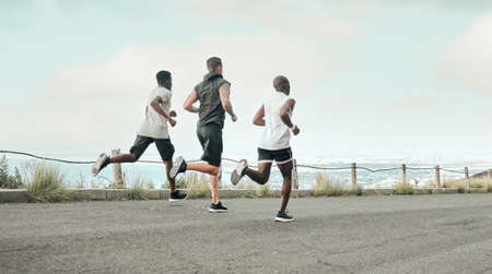 Were almost at the finish line. Shot of a group of men exercising in nature.の写真素材