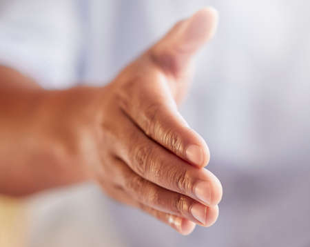 Put er there. Cropped shot of an unrecognizable businessman gesturing for a handshake while standing...
