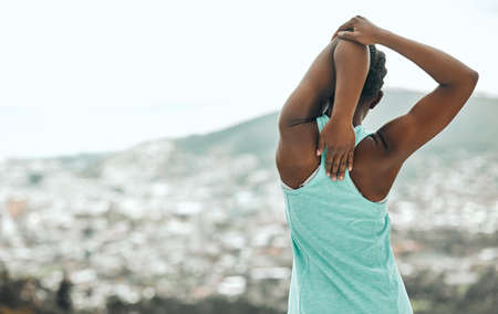 Stretching the stress away. Shot of an unrecognizable person stretching before a run.