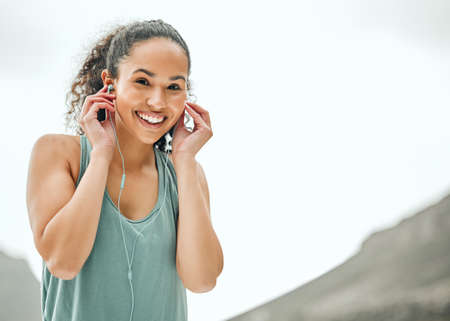 Ive got the perfect playlist. Shot of a young woman listening to music while on a run.