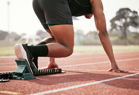 Practicing his take off. Rearview shot of an unrecognizable young male athlete starting his race on...