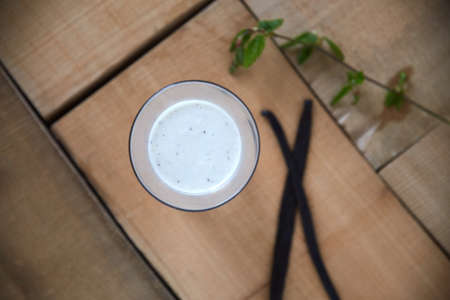 Start your day fresh. Overhead shot of a vanilla smoothie on a wooden table.