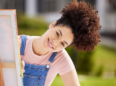 Mind if I paint you. Cropped portrait of an attractive young woman painting in the park.