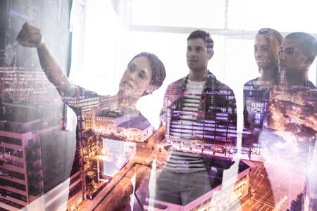 Re-evaluating plans to reinvent the city. Multiple exposure shot of a group of businesspeople...