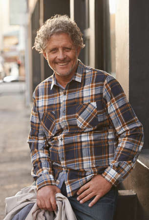 Style is timeless. Portrait of a friendly-looking middle aged man outside.の写真素材