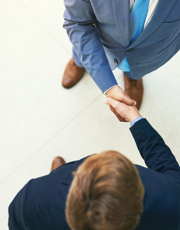Office partnerships. Shot of two businesspeople shaking hands.