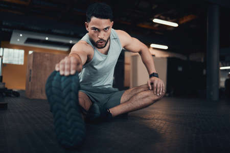 These calves need to be stretched. Shot of a young man stretching his leg.の写真素材