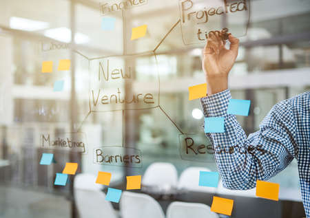 Giving his goals structure. Cropped shot of a man having a brainstorming session in a modern office.
