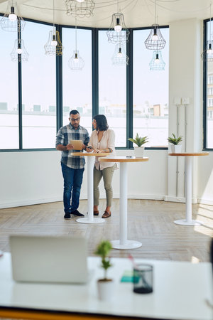 The right tools make all the difference in productive collaborations. Shot of two colleagues using a...