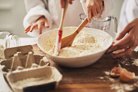 Lets get cooking. Cropped shot of a mother and her son baking in the kitchen.の写真素材