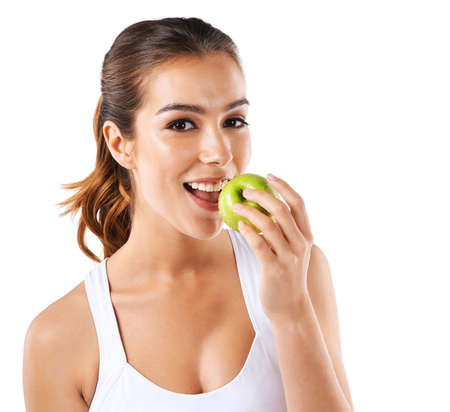 Be good to yourself. Cropped shot of a healthy young woman eating an apple.の写真素材