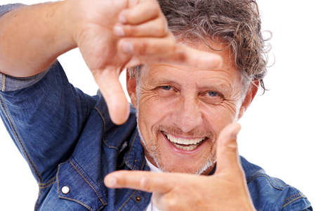 An isolated pose. Studio shot of a mature man isolated on white.