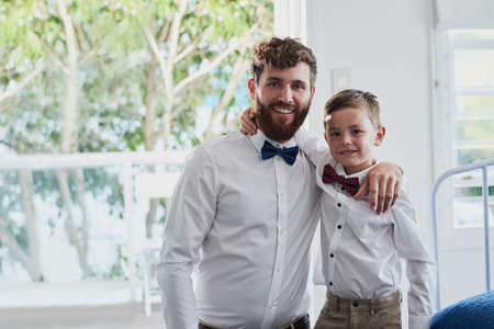 Looking dapper with Daddy. Portrait of an adorable little boy and his father dressed in matching outfits at home.の写真素材