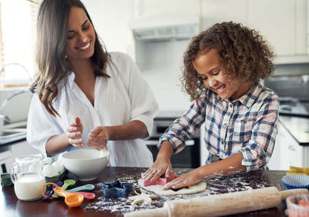 The freedom of adolescence. Shot of an adorable little girl baking with her mom at home.