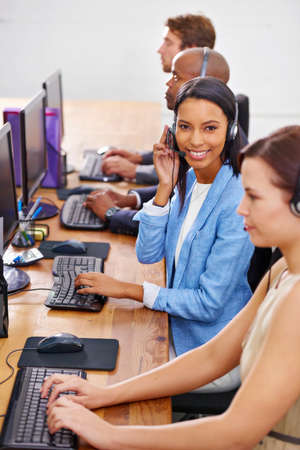 Were always online. Shot of customer service representatives in a call center.の写真素材