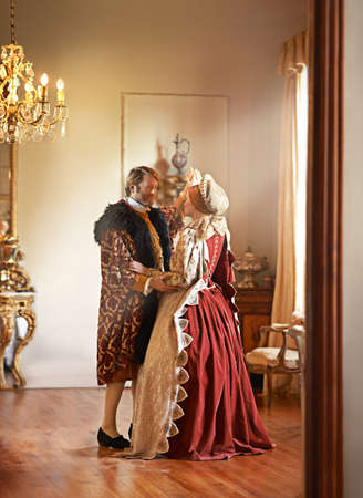 Sharing a tender moment. A king and queen dancing together in their palace.の写真素材