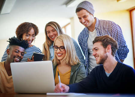 Students who work together in collaborative teams learn material better. Shot of a group of...