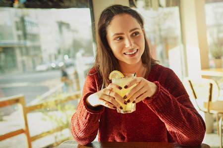The serve the best drinks here. Shot of a young woman enjoying a fresh beverage in a coffee shop.